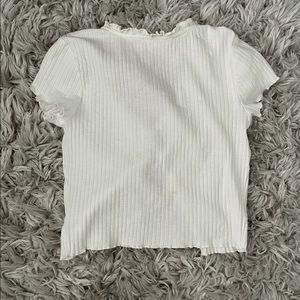 white crop top, open but ties in the middle